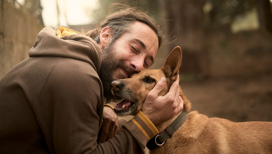 Owner gives a hug to his dog